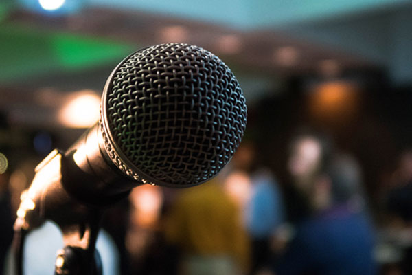 ES-Communications-Training-Services-Boston A photo of a microphone against a blurry background with a crowd visible