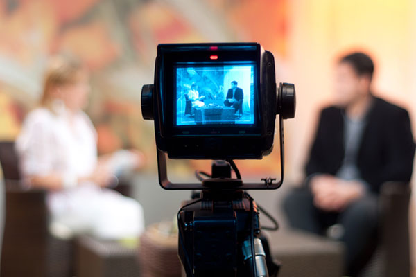 ES-Media-Training-Services-Boston A photo of a video camera recording an interview with blurred background