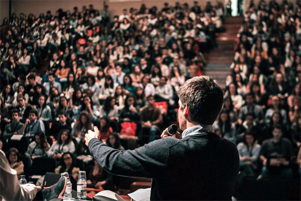ES-Presentation-Skills-Services-Boston A photo of a speaker in front of a blurred crowd
