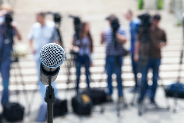 Photo of a crowd and microphone representing Ellis Strategies Crisis Management services