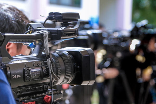 Photo of a camera and a crowd, representing Ellis Strategies Public Relations services